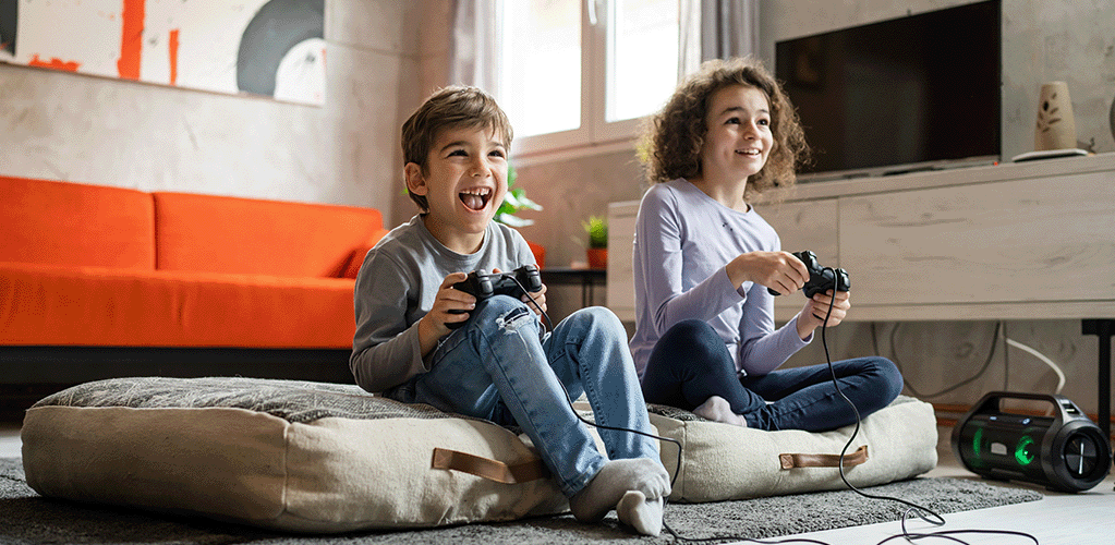 Kids playing online games at home using jurassic fibre broadband
