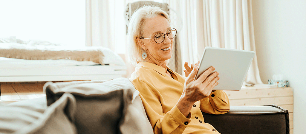 Woman viewing her tablet and enjoying low latency from Jurassic Fibre