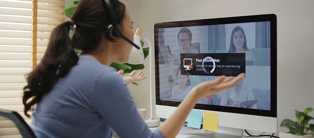 Woman sat at her desk waiting for her internet to stop buffering