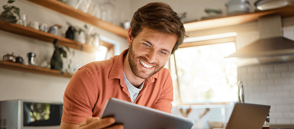 Man on his tablet in kitchen