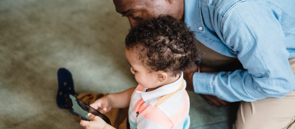 Young child on mobile with dad