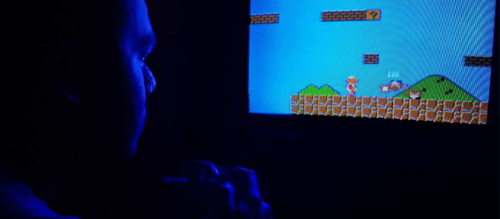 Man playing Mario in the dark