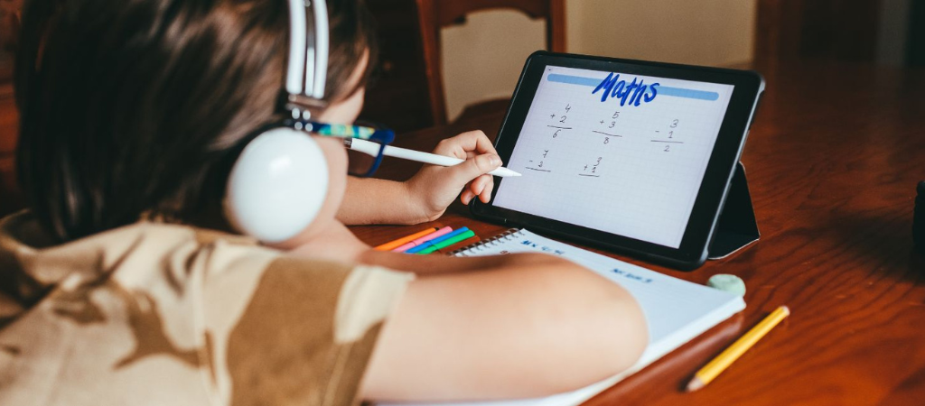 Kid on a tablet doing maths work